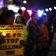 A Black Lives Matter protester holds a candle during a demonstration on March 23, 2018 in Sacramento, California